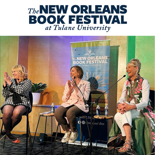 Three women on a stage at the New Orleans Book Festival at Tulane University, with a banner in the background.
